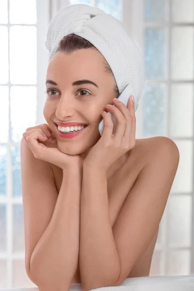 Woman speaking phone in the bathroom or spa salon — Stock Photo, Image