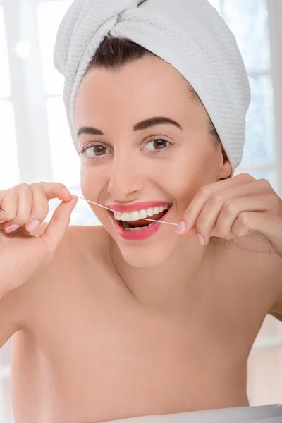 Woman cleaning teeth with floss — Stock Photo, Image