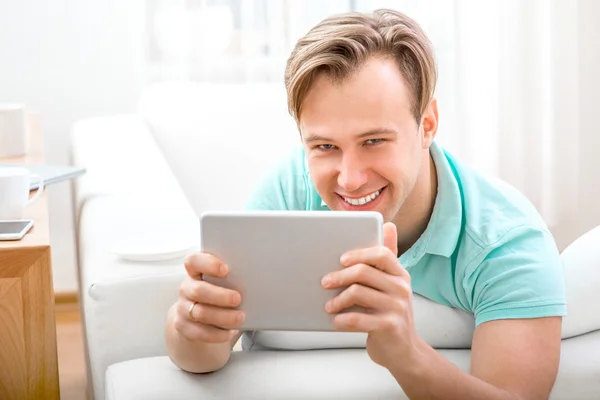 Homme avec gadget assis à la maison — Photo