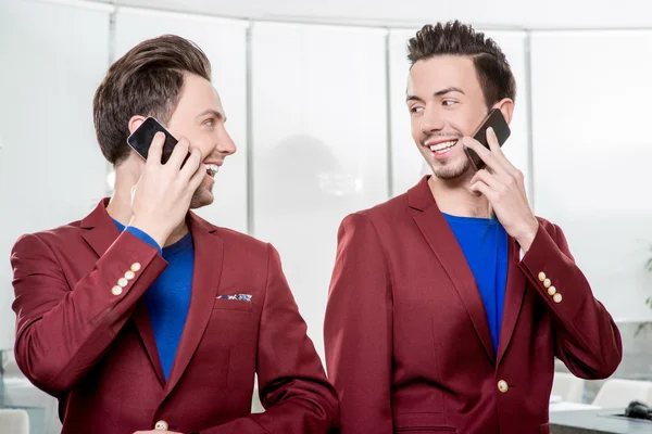 Business brothers twins with phones — Stock Photo, Image