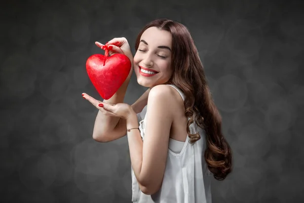 Woman with red heart Royalty Free Stock Photos