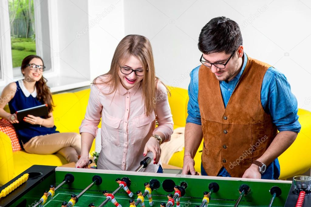 Friends playing table football