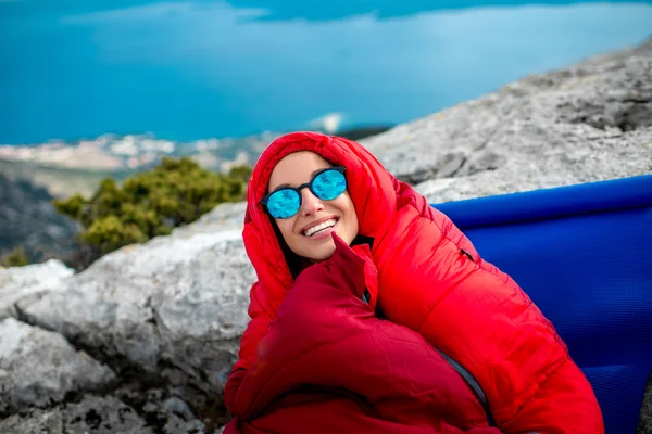 Femme dans un sac de couchage sur la montagne — Photo