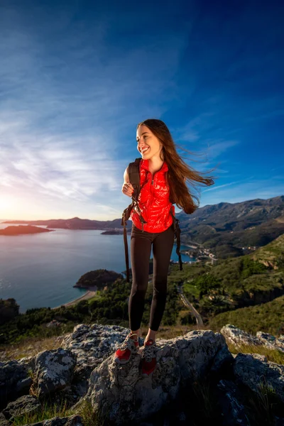 Sports woman on the top of mountain