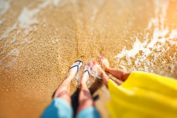 Couples legs in slippers on the beach — Stock Photo, Image