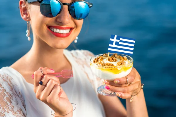 Woman eating greek yogurt — Stock Photo, Image