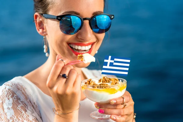 Woman eating greek yogurt — Stock Photo, Image