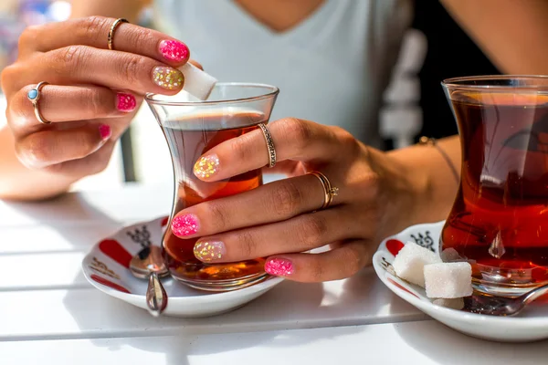 Holding turkish tea in traditional teacup — Stock Photo, Image