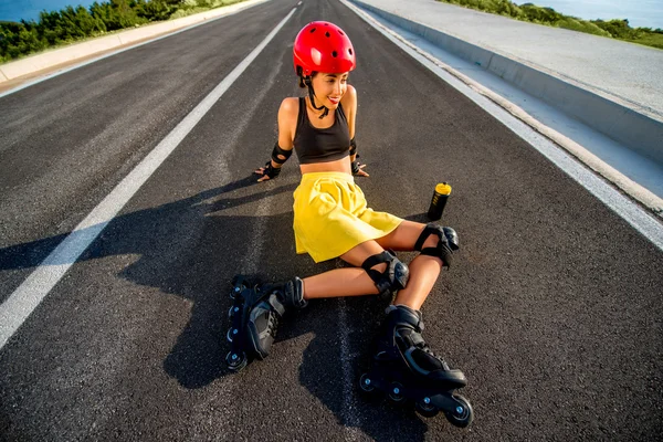 Sport woman with rollers on the highway — Stok fotoğraf