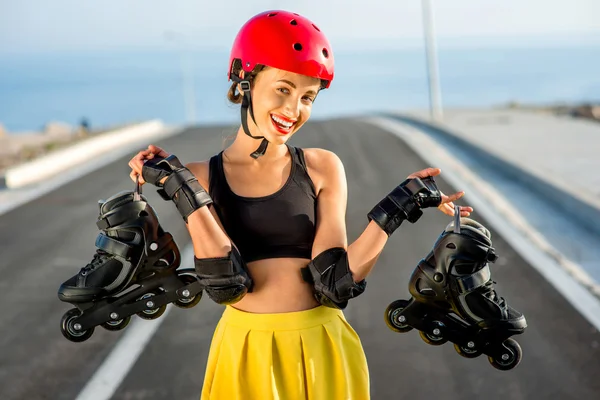 Sport woman with rollers on the highway — Stok fotoğraf