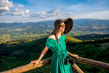 Woman on wooden terrace in the mountains