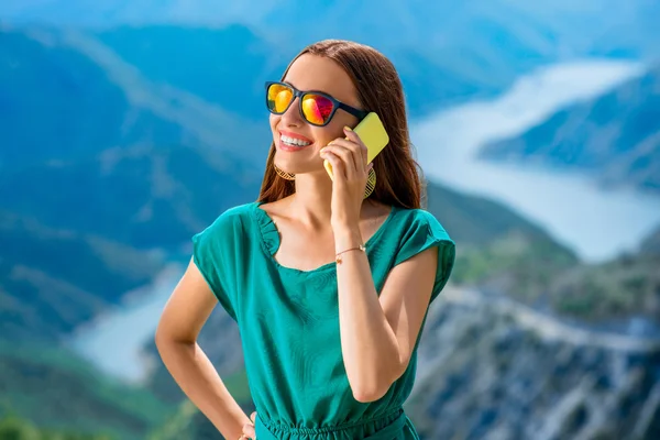 Woman with phone on the mountain — Stock Fotó