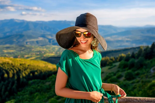 Woman on wooden terrace in the mountains — Stock fotografie