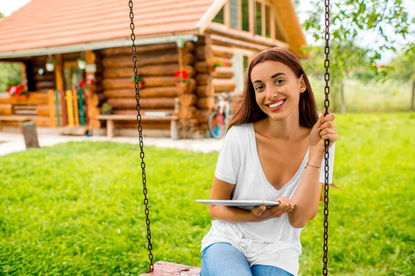 Relaxing in the garden near wooden house — Stok fotoğraf