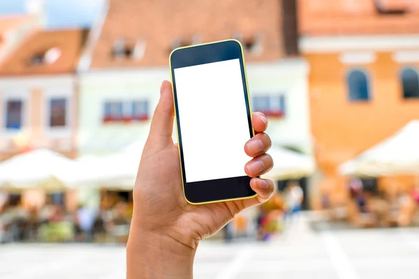 Phone with white screen on city background — Stock Photo, Image