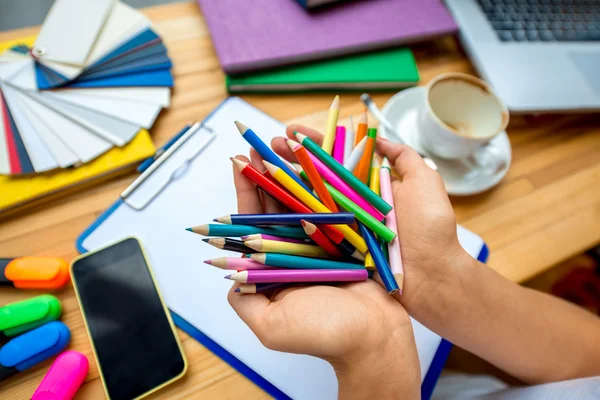 Holding kleurrijke potloden — Stockfoto