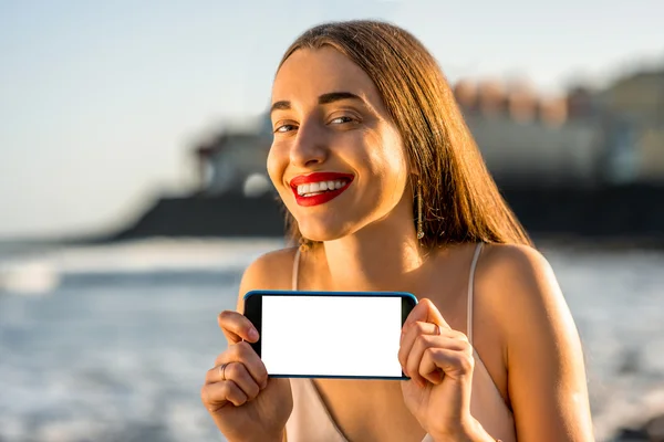 Woman showing phone with white screen — Stock Photo, Image