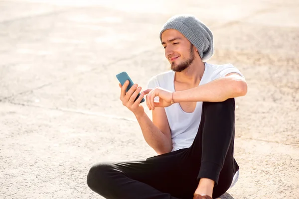 Muž s Kobaltová modř telefon na zem — Stock fotografie