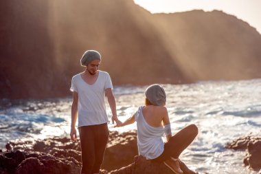 Couple together on the rocky coast