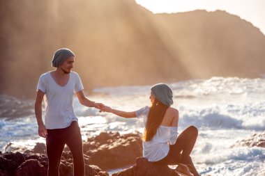 Couple together on the rocky coast