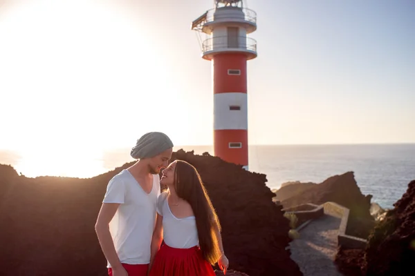 Couple standing together near the lighthouse — Stock Photo, Image