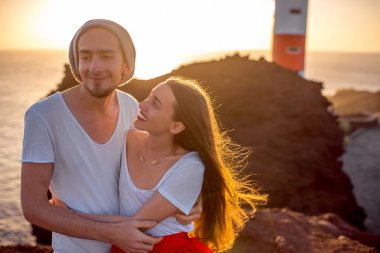 Couple enjoying summer vacation near the lighthouse