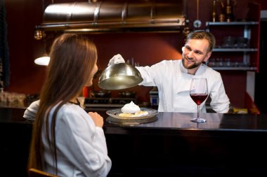 Chef cook serving dessert to the client