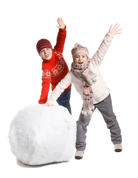 Children make a snowman in winter time, isolated — Stock Photo, Image