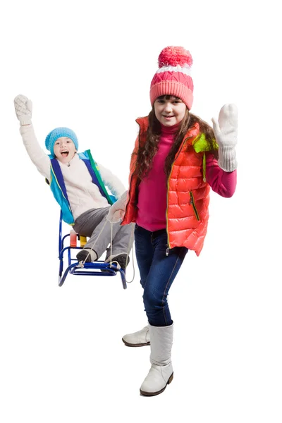Two happy girls in winter clothes on sled — Stock Photo, Image