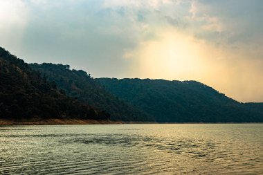 lake calm water with mountain background at day from flat angle image is taken at umiam lake shillong meghalaya india.