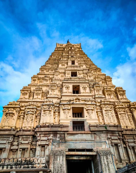 indian ancient temple entrance awesome stone work with bright blue sky image is taken at virupaksha tample hampi karnataka india.