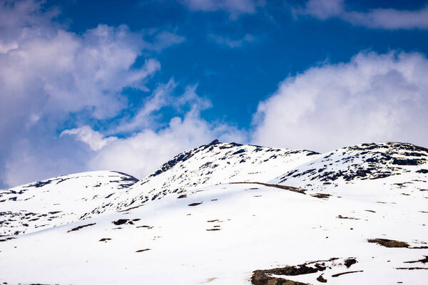 snow cap mountains with bright blue sky at day from flat angle image is taken at bumla pass arunachal pradesh india.