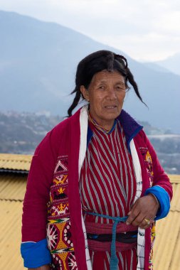 Monpa kabilesinin geleneksel elbise portreleri içinde yaşlı bir kadın detaylarla kapanıyor.