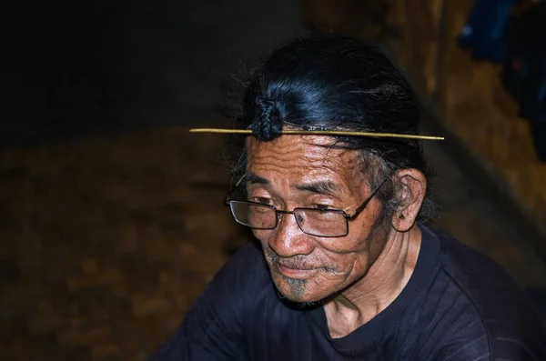 apatani tribal men facial expression with his traditional hair style and blurred background image is taken at ziro arunachal pradesh india. it is one of the oldest tribe of india.