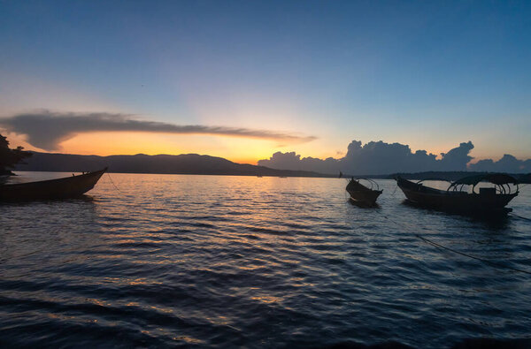traditional wooden boats floating on low light water