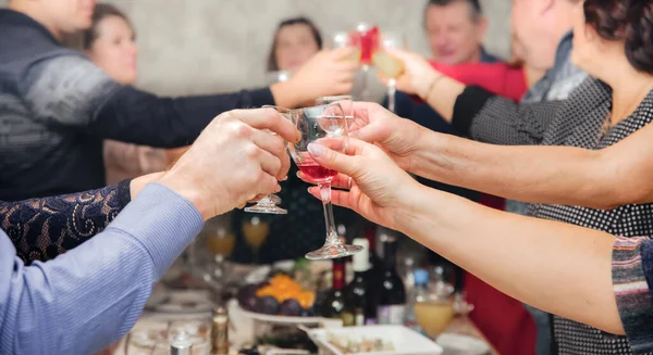 Hands holding glasses of wine while celebrating — Stock Photo, Image