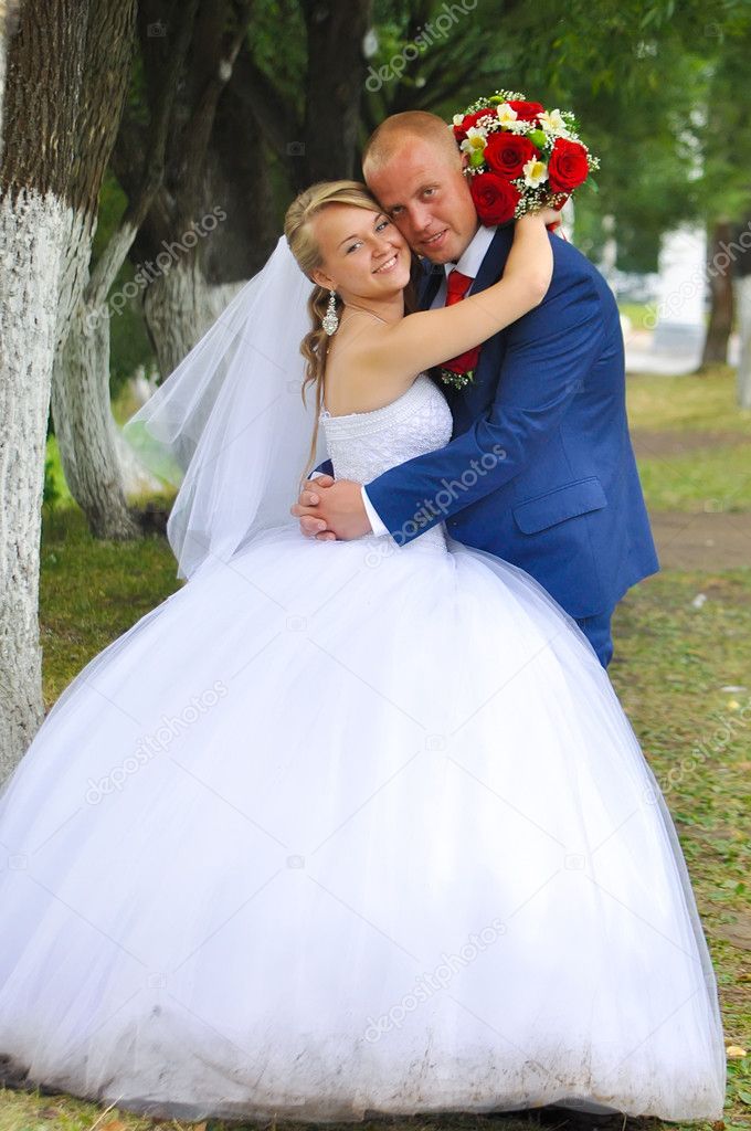 Happy bride and groom in the park