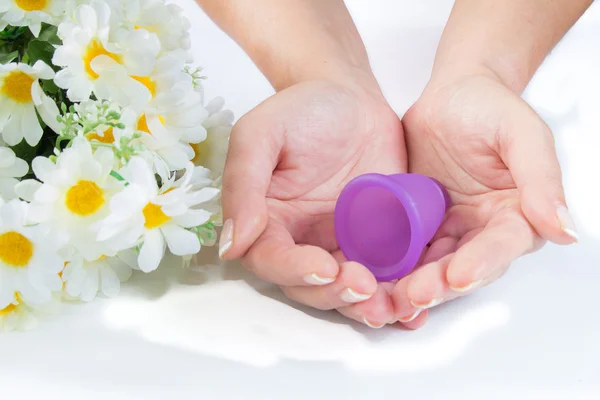 Hands, menstrual cup and flowers. — Stock Photo, Image