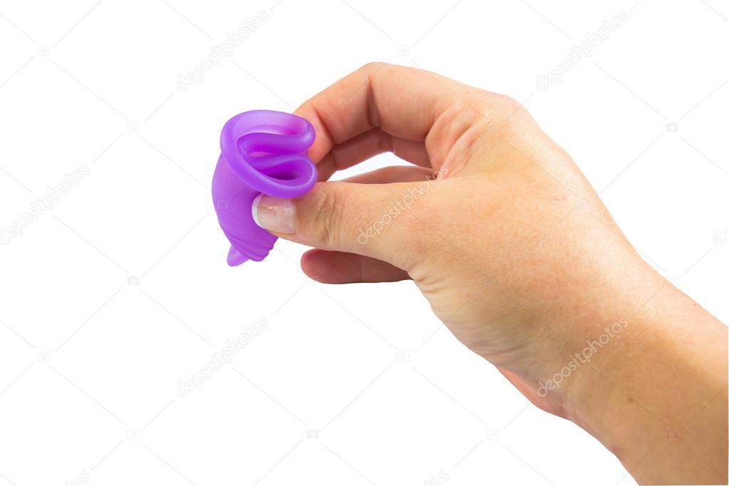 Woman hand folding a menstrual cup