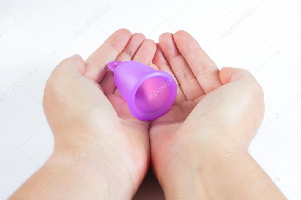 Hands holding a menstrual cup