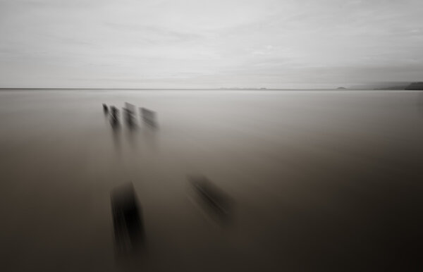 Black and white scene of the beach with radial blur effect.