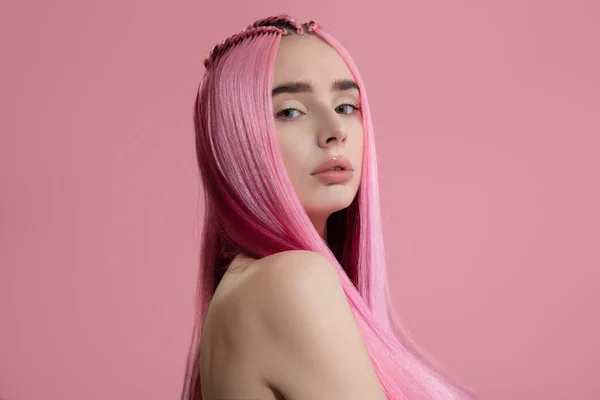 woman with dyed pink straight hair. Pink background. copycpase