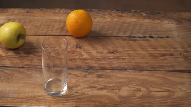 果物のセットの横に健康的なオレンジジュースを入れてください。 — ストック動画