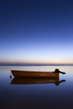 Calm island boat at Sunset