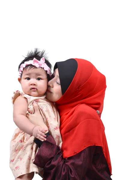 Young Asian muslim mother kissing her cute baby girl isolated on white background — Stock Photo, Image