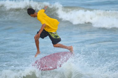 Kuantan - 29 Aralık: tanımlanamayan sörfçü dalgaları akşamları Teluk Cempedak beach adlı 29 Aralık 2012 Kuantan, Pahang, Malezya içinde yakalamak eylem.