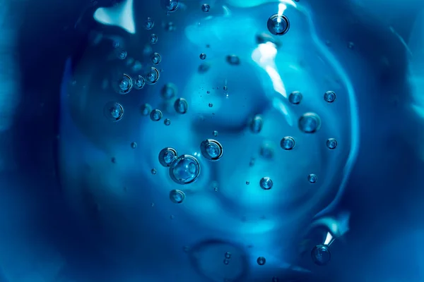 Abstract background of blue color bubbles in liquid.