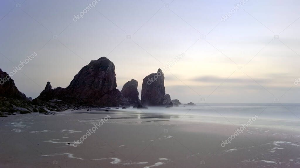 Remote rocky beach at dusk. Long esposure. Portugal. Analog: 35 mm film.