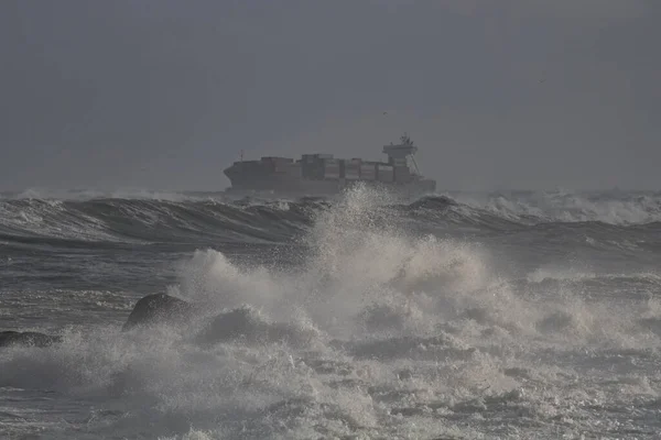 Container ship crossing the Portuguese coast on a stormy day. FOCUS ON THE FOREGROUND.