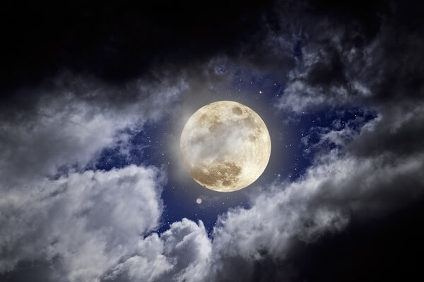 Full moon in a cloudy night with stars